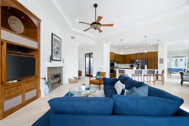 a living room with fireplace furniture and a flat screen tv
