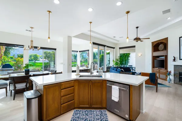 a kitchen with a sink stove and wooden floor