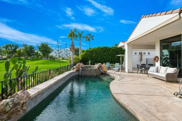 a view of a house with backyard porch and sitting area