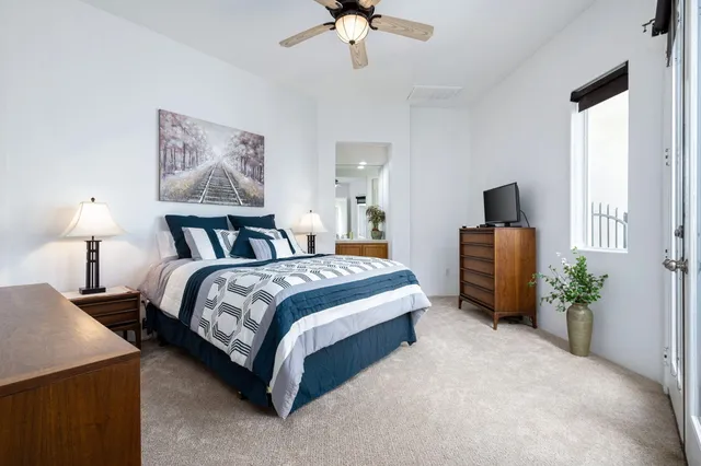 a bedroom with bed and a chandelier