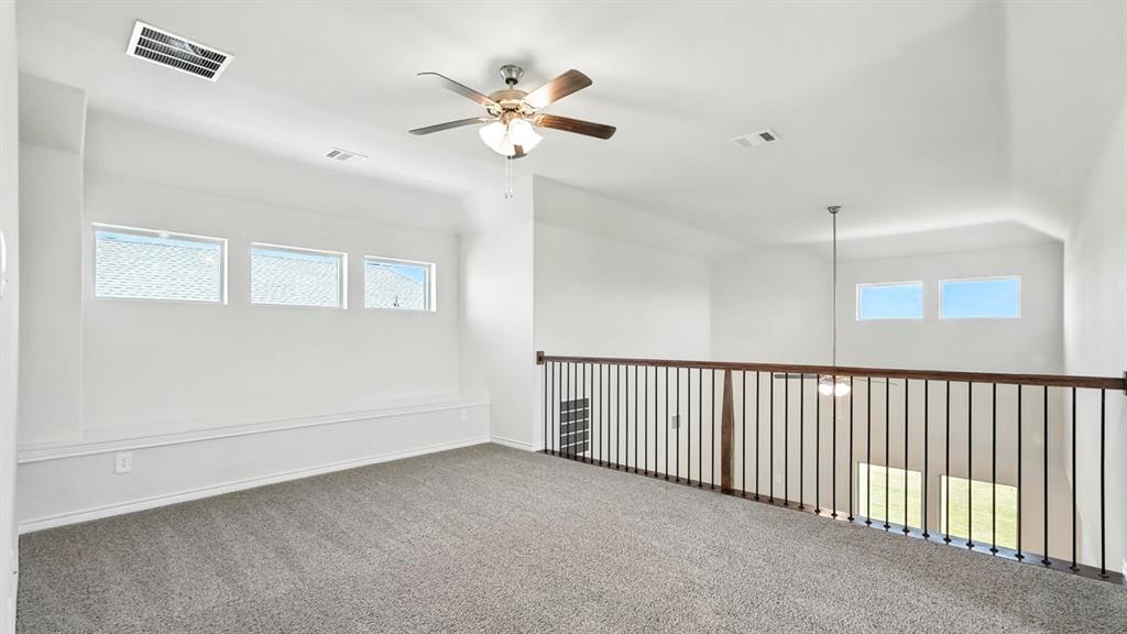 4159 Waldron Trail Forney, TX 75126 - Photo 12 of 19 Spacious open-concept area featuring a ceiling fan, plush carpet, and natural light from transom windows