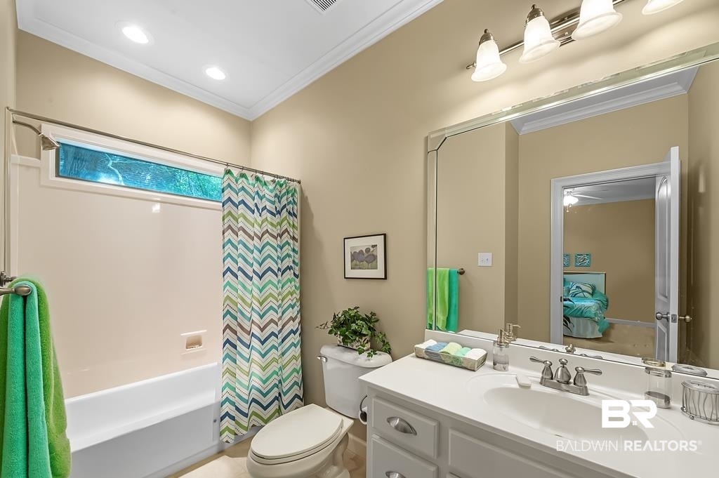 29976 Dolive Ridge Daphne, AL 36527 - Photo 39 of 58 Full bathroom featuring vanity, crown molding, toilet, and shower / bath combination with curtain