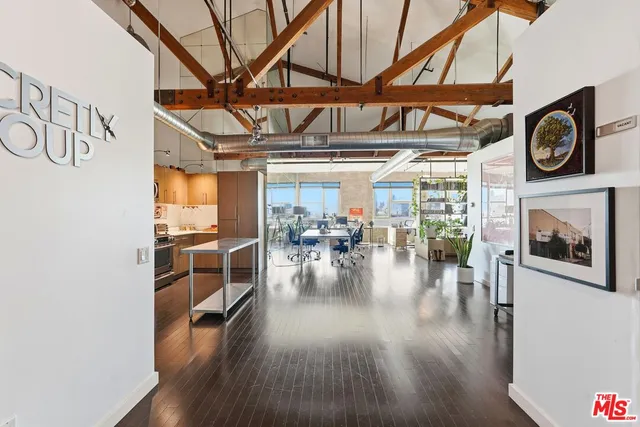 a view of a livingroom with furniture wooden floor and a ceiling fan