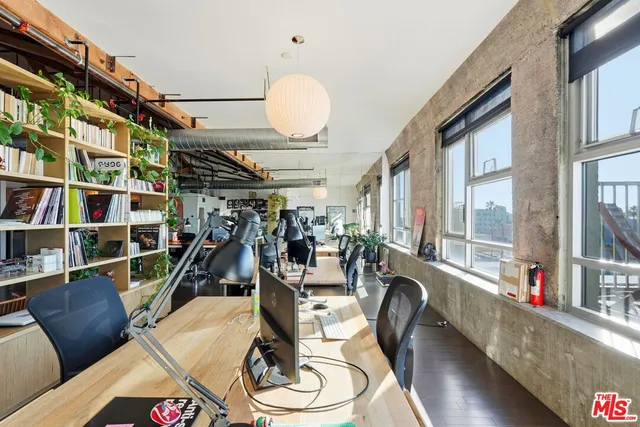 a view of a balcony with wooden floor and seating space