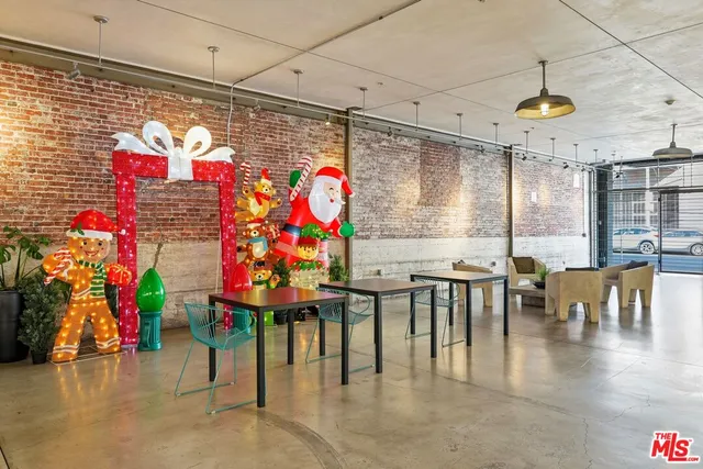 a store with outdoor seating area and flowers