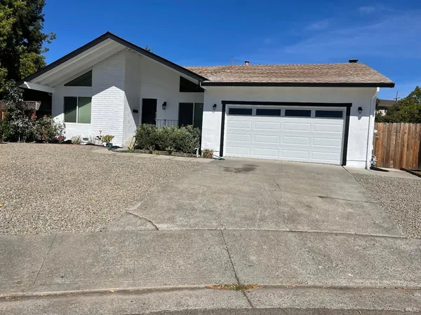 a view of a house with a yard and garage