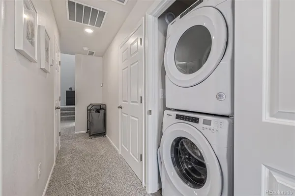 a view of a hallway with washer and dryer
