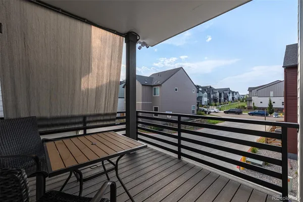 a terrace of a house with wooden floor outdoor seating and yard