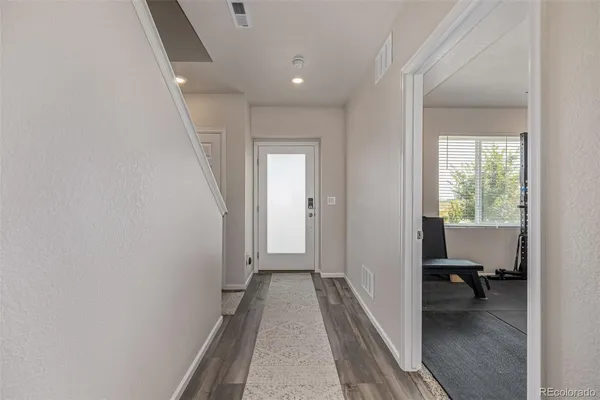 a view of a hallway with a room and a bathroom