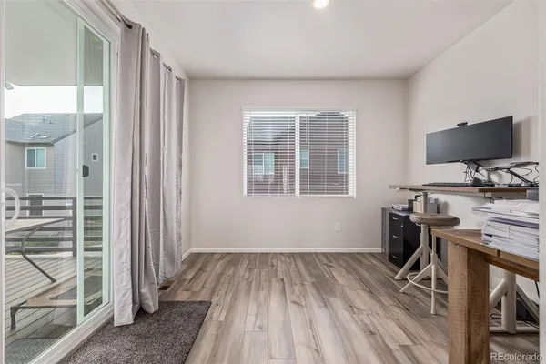 a view of workspace with wooden floor windows wardrobe