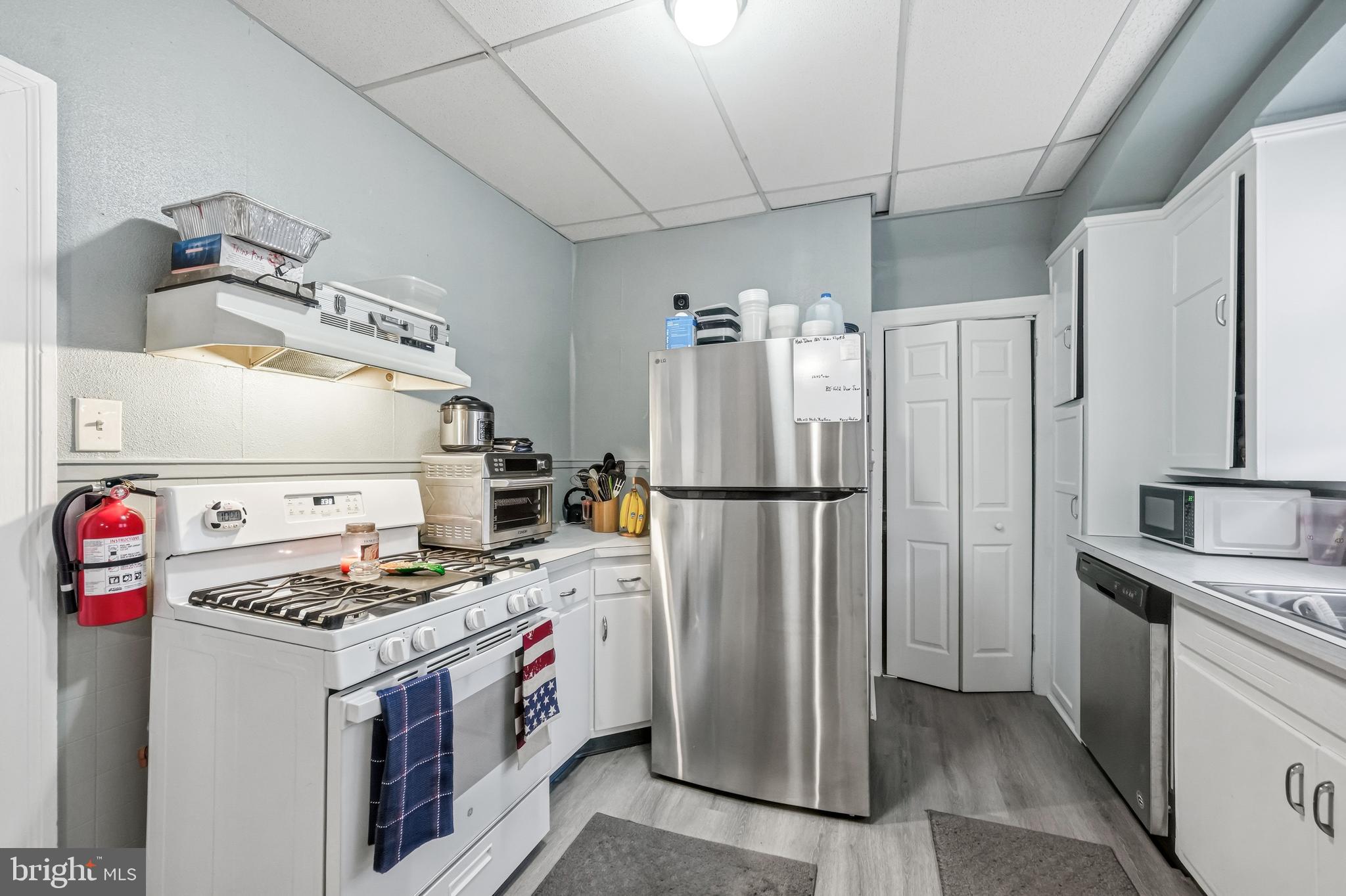 227 Heulings Avenue Riverside, NJ 08075 - Photo 11 of 45 a kitchen with a refrigerator and a stove