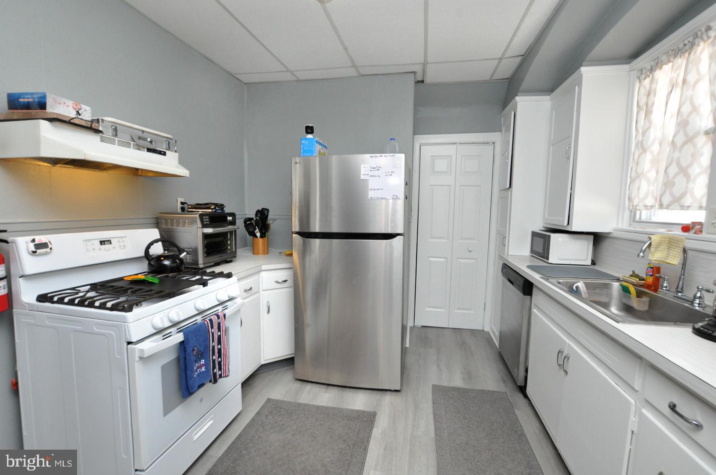 227 Heulings Avenue Riverside, NJ 08075 - Photo 12 of 45 a kitchen with a stove a refrigerator and a sink