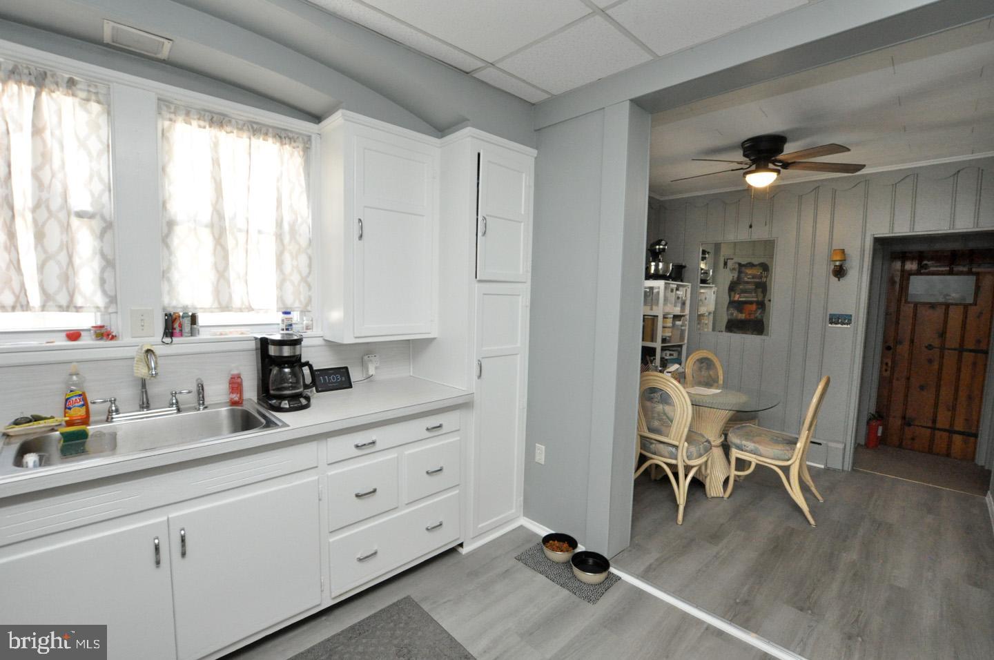 227 Heulings Avenue Riverside, NJ 08075 - Photo 13 of 45 a kitchen with stainless steel appliances kitchen island granite countertop a table chairs refrigerator and cabinets