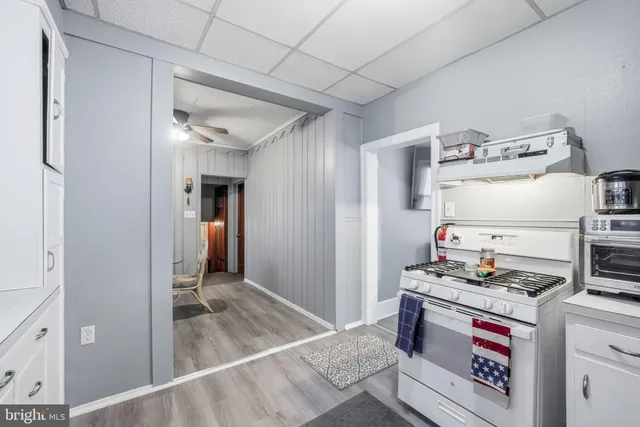 a kitchen with refrigerator and cabinets