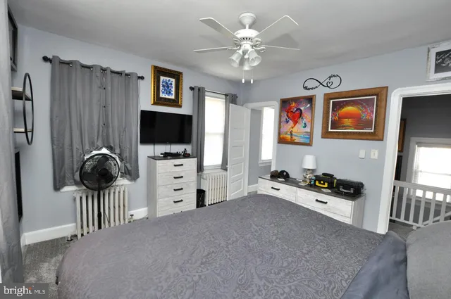a living room with furniture and flat screen tv