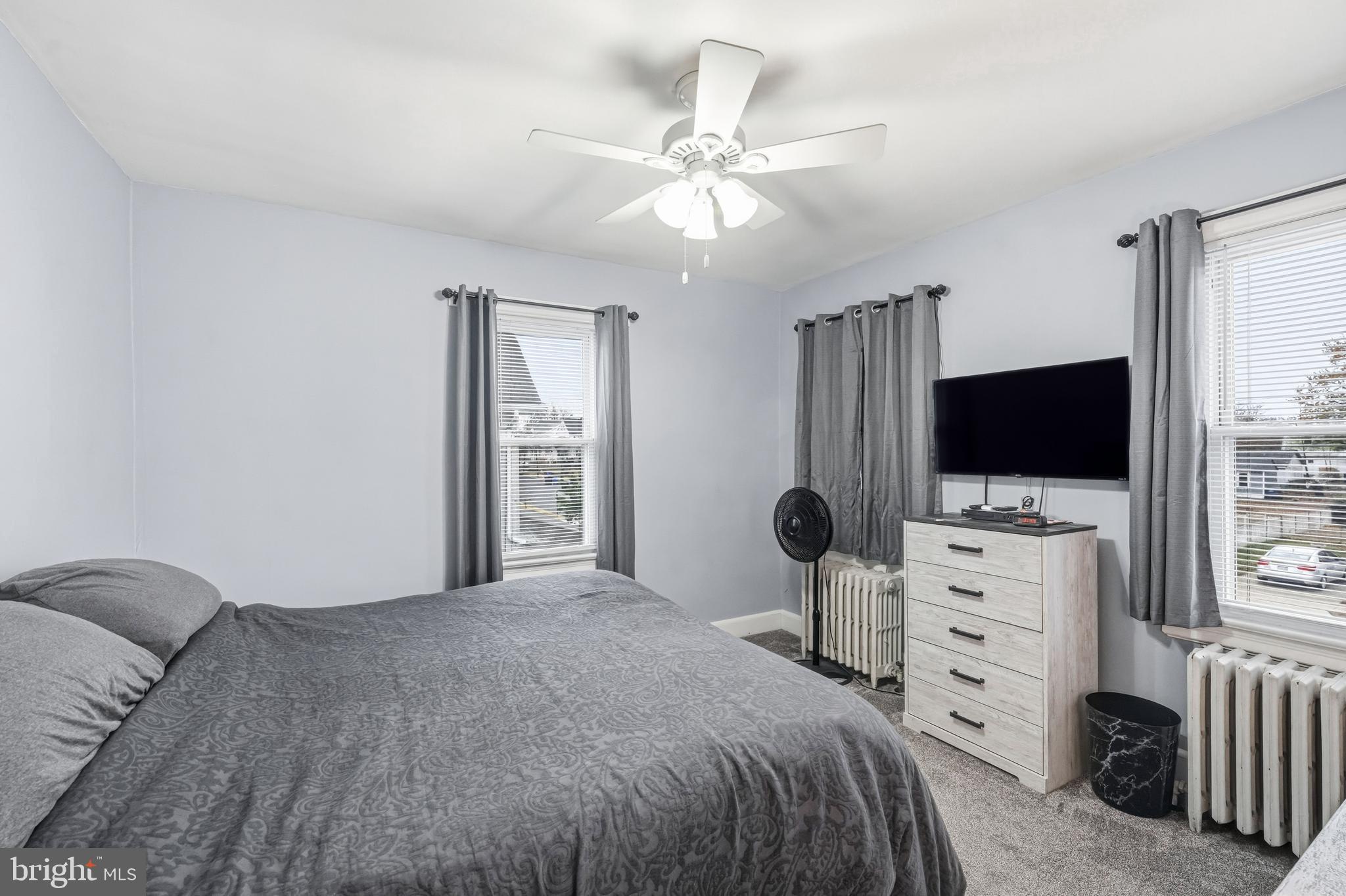 227 Heulings Avenue Riverside, NJ 08075 - Photo 25 of 45 a bedroom with a bed and a flat screen tv