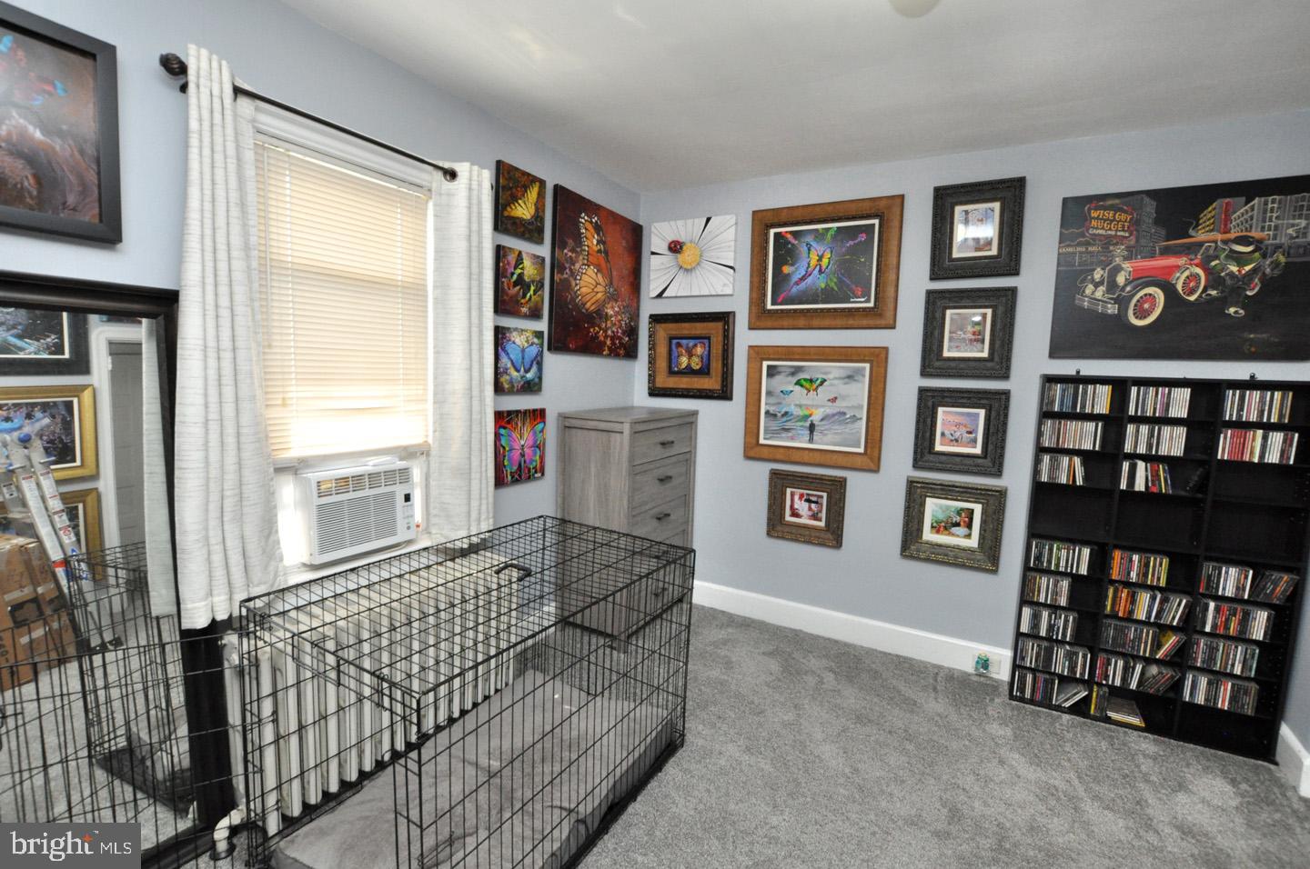 227 Heulings Avenue Riverside, NJ 08075 - Photo 28 of 45 a living room with fish tank and a bookshelf