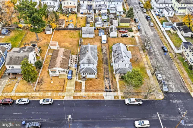 an aerial view of residential houses with yard