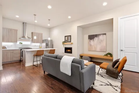 a kitchen with a stove a refrigerator and a fireplace