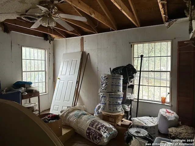 a living room with furniture and floor to ceiling window