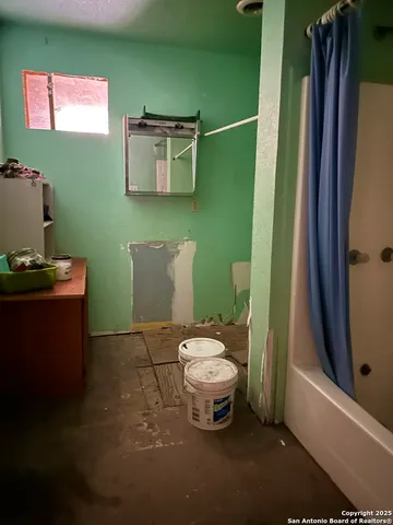 a bathroom with a toilet and a mirror