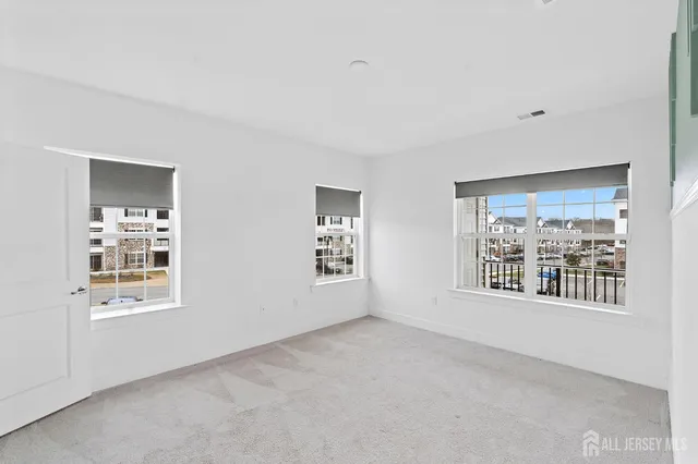 a bedroom with a large bed and a potted plant