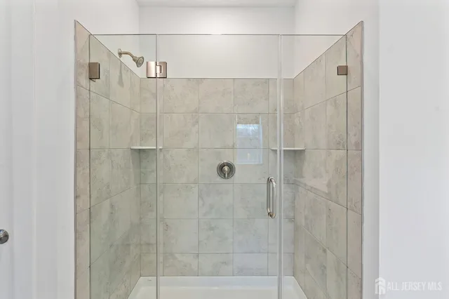 a bathroom with a double vanity sink a shower and a mirror