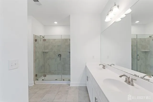 a bathroom with a double vanity sink toilet and a mirror