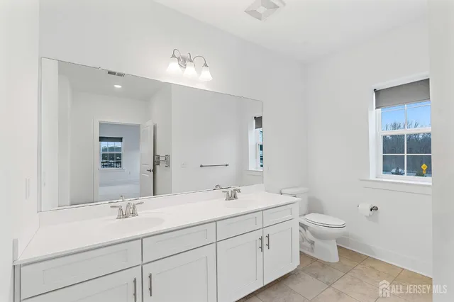 a view of a room with wooden floor and white cabinet