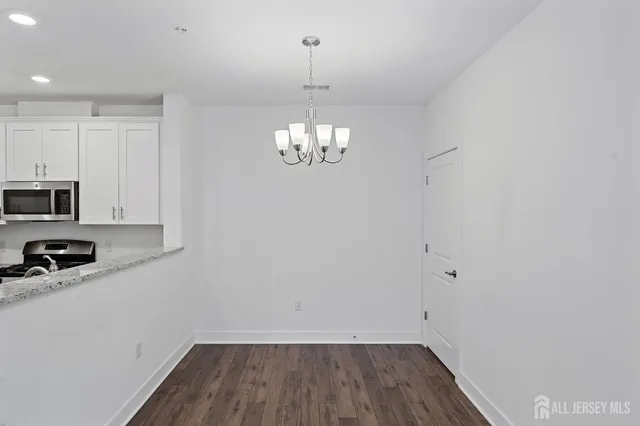 a dining room with furniture and chandelier