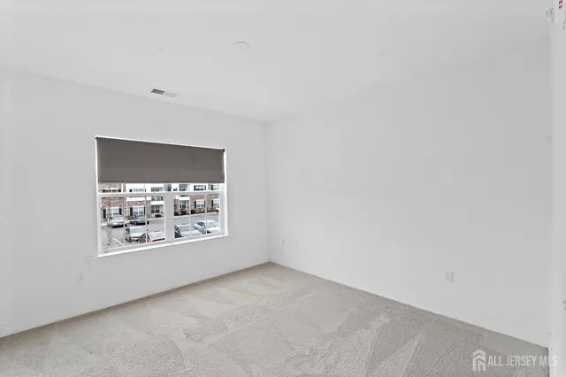 a bedroom with a large bed and a potted plant