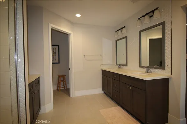 a bathroom with a double vanity sink and mirror