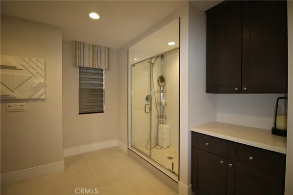 a bathroom with a shower sink and mirror