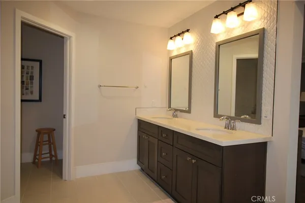 a bathroom with a double vanity sink and a mirror