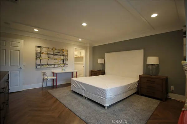 a spacious bedroom with a bed and window