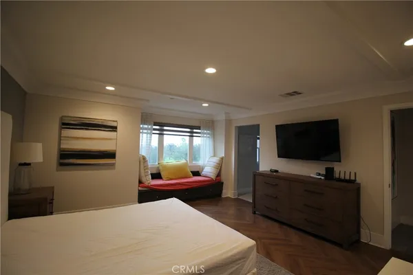 a bedroom with furniture and flat screen tv