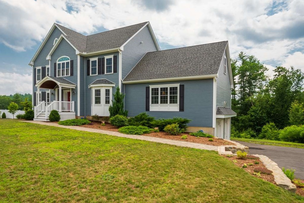3 Quail Ridge Road Merrimac, MA 01860 - Photo 2 of 36 a front view of house with yard and green space