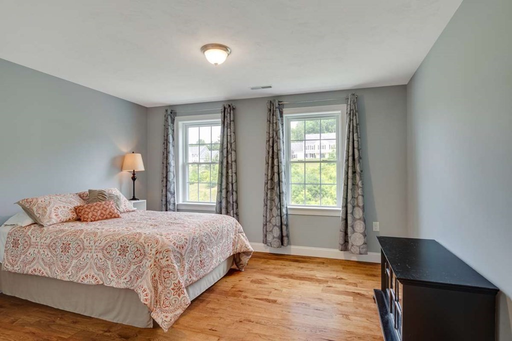 3 Quail Ridge Road Merrimac, MA 01860 - Photo 27 of 36 a bedroom with a bed and wooden floor