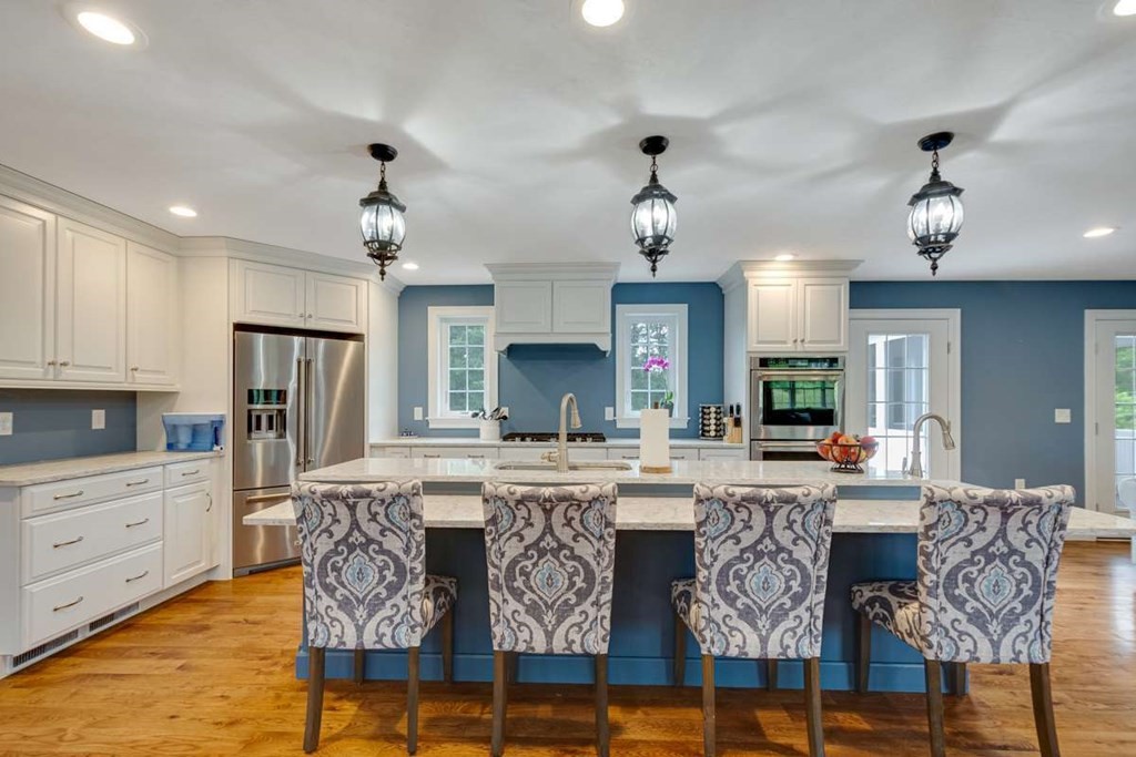 3 Quail Ridge Road Merrimac, MA 01860 - Photo 4 of 36 a kitchen with stainless steel appliances granite countertop a stove top oven a sink a dining table and chairs with wooden floor