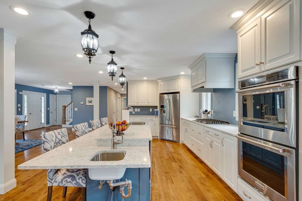 3 Quail Ridge Road Merrimac, MA 01860 - Photo 6 of 36 a large kitchen with stainless steel appliances kitchen island granite countertop a table chairs in it and a granite counter tops