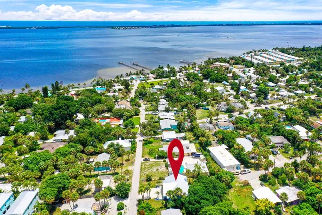 an aerial view of a house with a yard and garden
