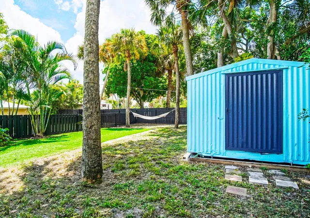 a backyard of a house with yard and barbeque oven