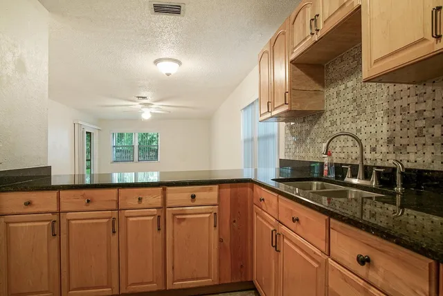 an empty room with closet and a chandelier fan