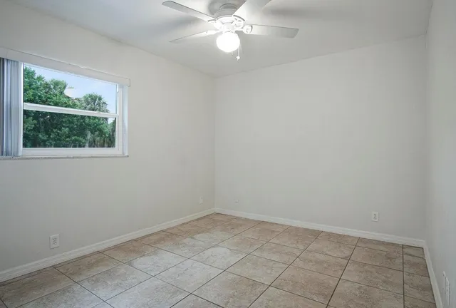 a view of kitchen with granite countertop cabinets and window
