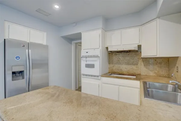 a kitchen with a sink cabinets and stainless steel appliances