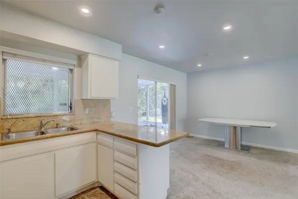 a kitchen that has a sink and a stove in it
