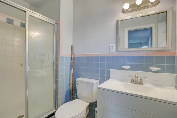 a bathroom with a sink a toilet and mirror