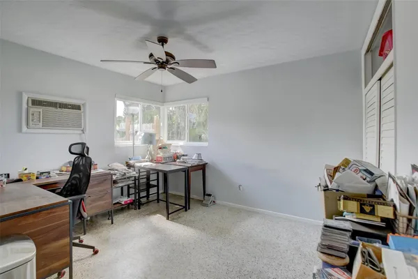 a view of a workspace with furniture and a window