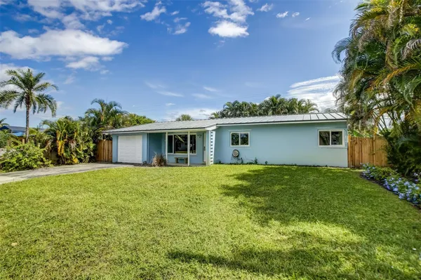 a front view of house with yard and trees