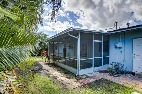 a view of a house with a yard and sitting area
